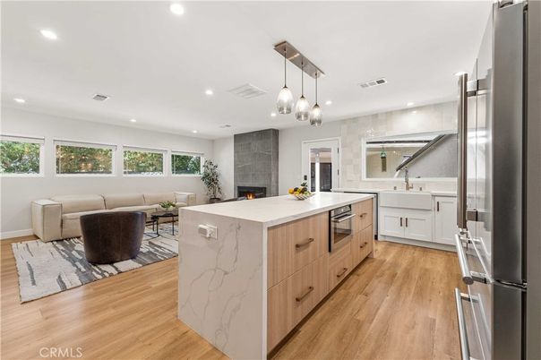 Fireplace, Interior, Kitchen, Living room, Pendant Lights, Recessed Lighting, Stainless Steel Appliances, Wood Texture Flooring