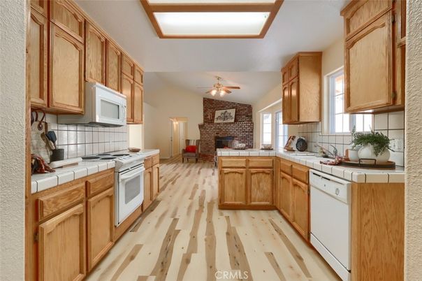 Fireplace, Interior, Kitchen, Stone Walls, Tile Countertops, Wood Texture Flooring