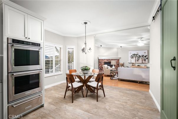Dining room, Fireplace, Interior, Kitchen, Living room, Pendant Lights, Stainless Steel Appliances, Wood Texture Flooring