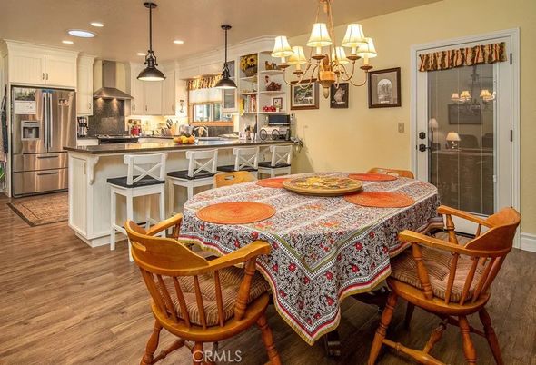 Chandelier, Dining room, Interior, Kitchen, Pendant Lights, Recessed Lighting, Stainless Steel Appliances, Wood Texture Flooring