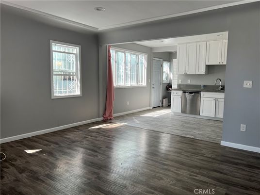 Empty room, Interior, Kitchen, Recessed Lighting, Stainless Steel Appliances, Wood Texture Flooring
