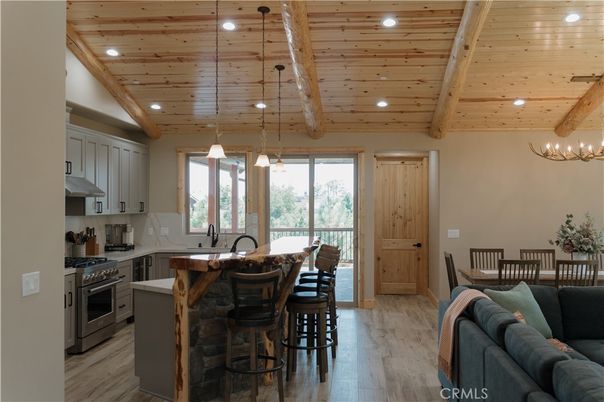 Chandelier, Dining room, Interior, Kitchen, Pendant Lights, Recessed Lighting, Stainless Steel Appliances, Wooden Beams, Wooden Ceilings, Wood Texture Flooring