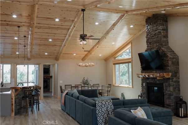 Chandelier, Dining room, Fireplace, Interior, Living room, Recessed Lighting, Stone Walls, Wooden Beams, Wooden Ceilings, Wood Texture Flooring