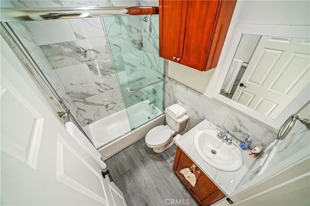 Bathroom, Glass Shower, Interior, Marble Walls, Wood Texture Flooring
