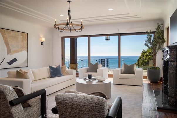 Chandelier, Fireplace, Interior, Living room, Recessed Lighting, Water, Wood Texture Flooring
