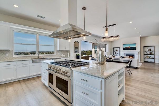 Chandelier, Dining room, Fireplace, Interior, Kitchen, Living room, Pendant Lights, Recessed Lighting, Stainless Steel Appliances, Wood Texture Flooring