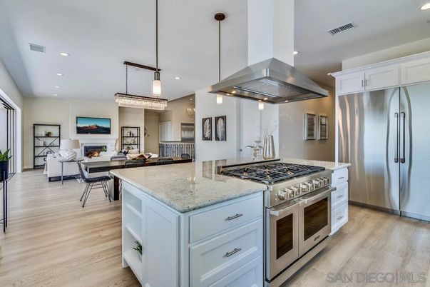 Chandelier, Dining room, Fireplace, Interior, Kitchen, Living room, Pendant Lights, Recessed Lighting, Stainless Steel Appliances, Wood Texture Flooring