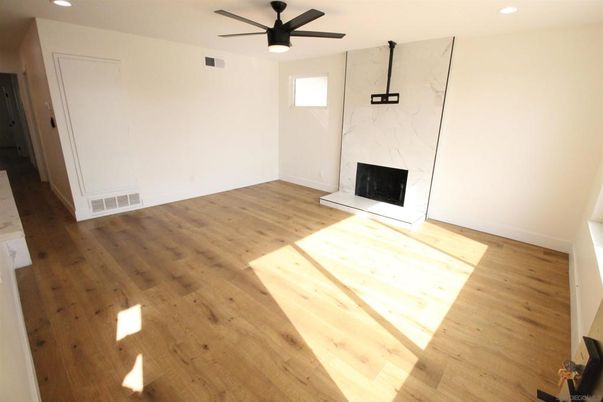 Empty room, Fireplace, Interior, Marble Walls, Recessed Lighting, Wood Texture Flooring
