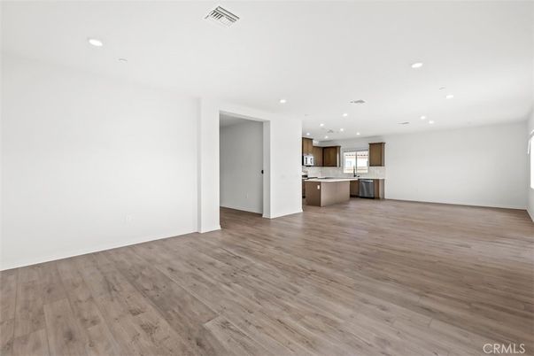 Empty room, Interior, Kitchen, Pendant Lights, Recessed Lighting, Stainless Steel Appliances, Wood Texture Flooring