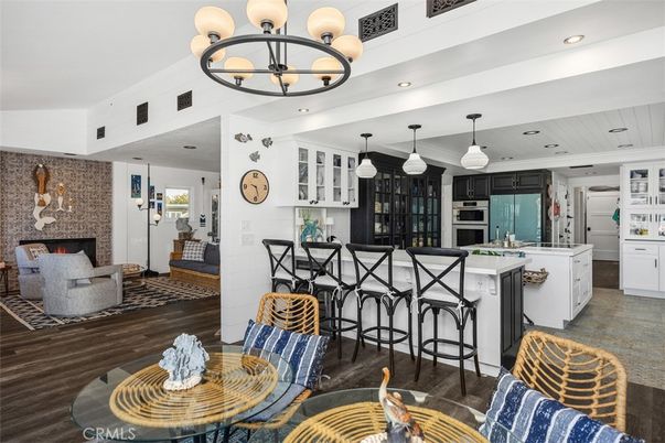 Chandelier, Fireplace, Interior, Kitchen, Living room, Pendant Lights, Recessed Lighting, Wood Texture Flooring
