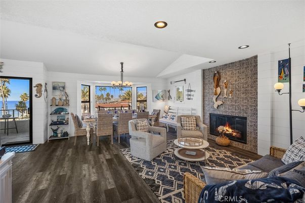Chandelier, Dining room, Fireplace, Interior, Living room, Recessed Lighting, Stone Walls, Water, Wood Texture Flooring