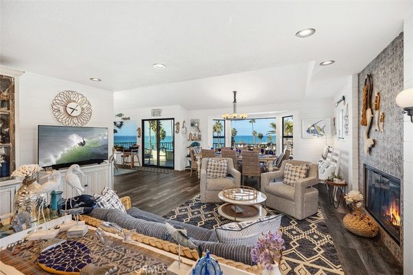 Chandelier, Dining room, Fireplace, Interior, Living room, Recessed Lighting, Water, Wood Texture Flooring