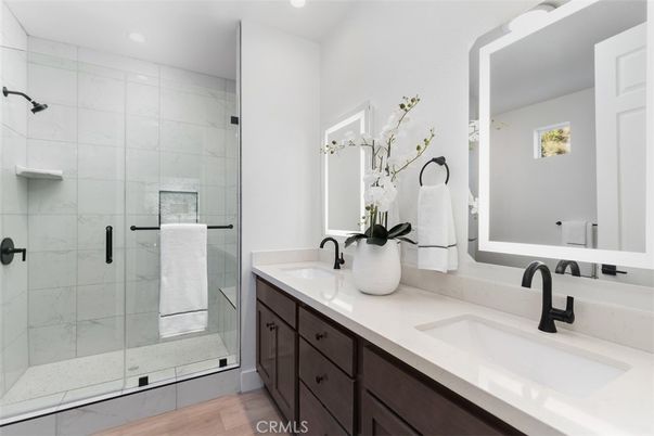 Bathroom, Dual Sink Vanities, Glass Shower, Interior, Marble Walls, Recessed Lighting, Wood Texture Flooring
