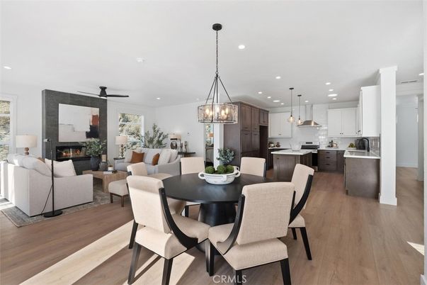 Chandelier, Dining room, Fireplace, Interior, Kitchen, Living room, Pendant Lights, Recessed Lighting, Stainless Steel Appliances, Wood Texture Flooring