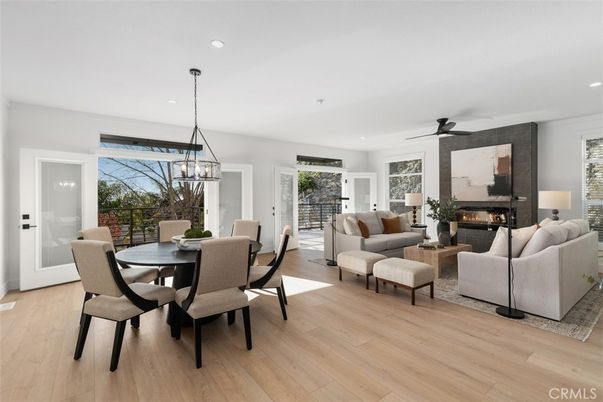Chandelier, Dining room, Fireplace, Interior, Living room, Pendant Lights, Recessed Lighting, Wood Texture Flooring
