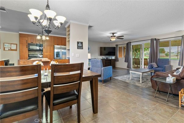 Chandelier, Dining room, Interior, Kitchen, Living room, Stainless Steel Appliances, Wood Texture Flooring