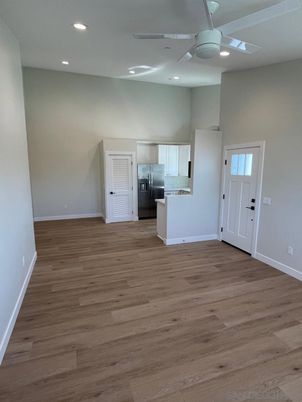 Empty room, Interior, Kitchen, Recessed Lighting, Stainless Steel Appliances, Wood Texture Flooring