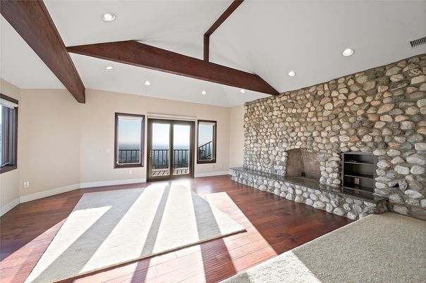 Empty room, Fireplace, Interior, Recessed Lighting, Stone Walls, Wooden Beams, Wood Texture Flooring