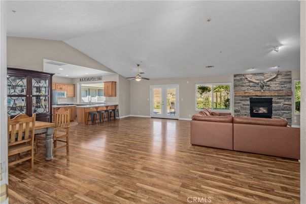 Dining room, Fireplace, Interior, Kitchen, Living room, Recessed Lighting, Stone Walls, Wood Texture Flooring