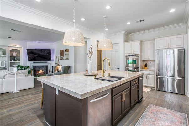 Fireplace, Interior, Kitchen, Living room, Pendant Lights, Recessed Lighting, Stainless Steel Appliances, Wood Texture Flooring