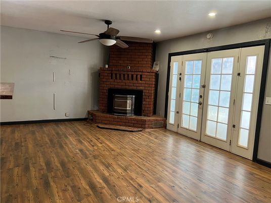 Empty room, Fireplace, Interior, Recessed Lighting, Stone Walls, Wood Texture Flooring