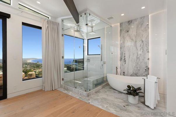 Bathroom, Free Standing Baths, Glass Shower, Interior, Marble, Marble Walls, Recessed Lighting, Water, Wood Texture Flooring