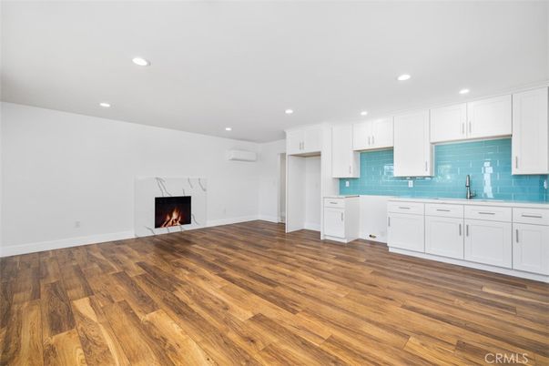 Empty room, Fireplace, Interior, Kitchen, Recessed Lighting, Wood Texture Flooring