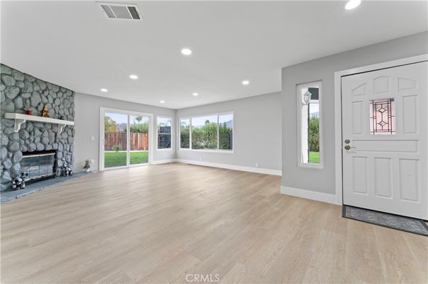 Empty room, Fireplace, Interior, Recessed Lighting, Stone Walls, Wood Texture Flooring