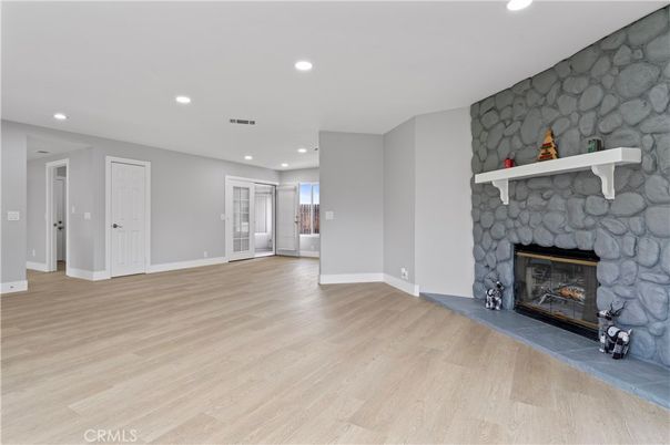 Empty room, Fireplace, Interior, Recessed Lighting, Stone Walls, Wood Texture Flooring