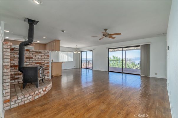 Empty room, Fireplace, Interior, Kitchen, Pendant Lights, Recessed Lighting, Stone Walls, Wood Texture Flooring