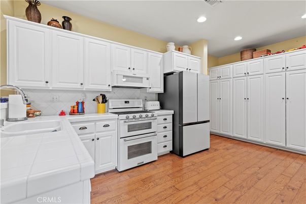 Interior, Kitchen, Recessed Lighting, Tile Countertops, Wood Texture Flooring