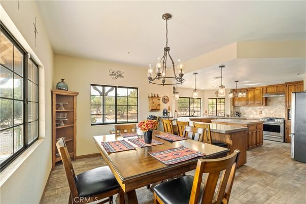 Chandelier, Dining room, Interior, Kitchen, Pendant Lights, Stainless Steel Appliances, Wood Texture Flooring