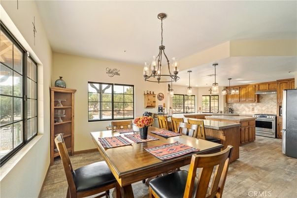 Chandelier, Dining room, Interior, Kitchen, Pendant Lights, Stainless Steel Appliances, Wood Texture Flooring