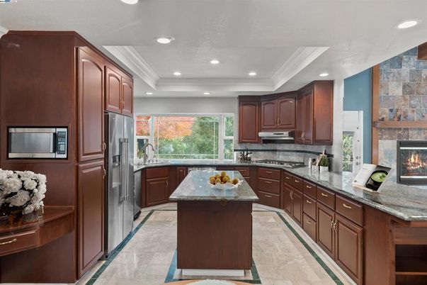 Fireplace, Interior, Kitchen, Recessed Lighting, Stainless Steel Appliances, Stone Walls