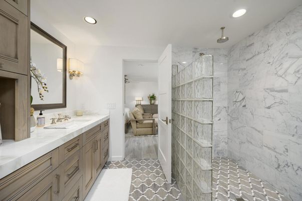 Bathroom, Dual Sink Vanities, Glass Shower, Interior, Marble Walls, Recessed Lighting, Wood Texture Flooring