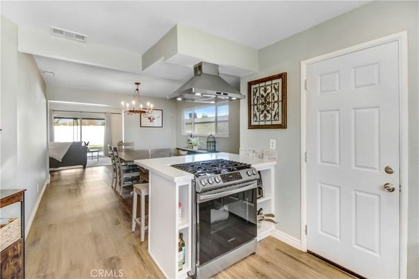 Chandelier, Dining room, Interior, Kitchen, Stainless Steel Appliances, Wood Texture Flooring