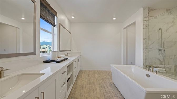 Bathroom, Dual Sink Vanities, Free Standing Baths, Interior, Marble Walls, Recessed Lighting, Wood Texture Flooring