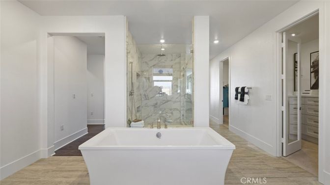 Bathroom, Free Standing Baths, Glass Shower, Interior, Marble Walls, Recessed Lighting, Wood Texture Flooring