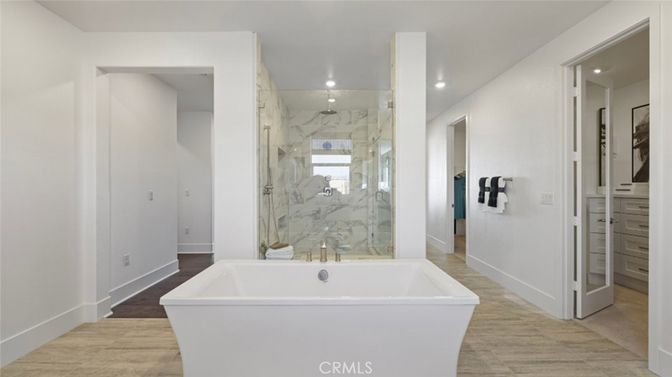 Bathroom, Free Standing Baths, Glass Shower, Interior, Marble Walls, Recessed Lighting, Wood Texture Flooring