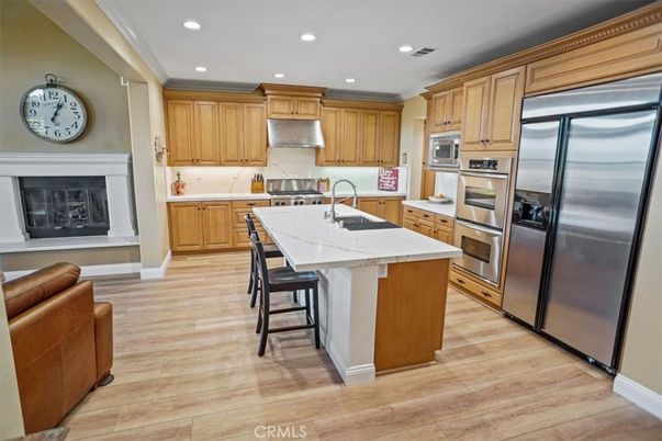 Fireplace, Interior, Kitchen, Recessed Lighting, Stainless Steel Appliances, Wood Texture Flooring