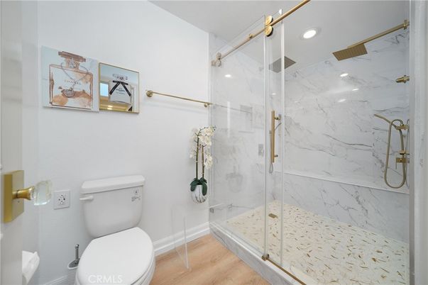 Bathroom, Glass Shower, Interior, Marble Walls, Recessed Lighting, Wood Texture Flooring
