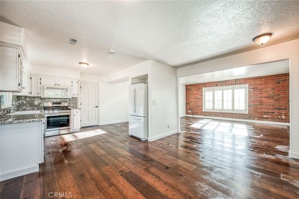 Empty room, Interior, Kitchen, Stainless Steel Appliances, Stone Walls, Wood Texture Flooring