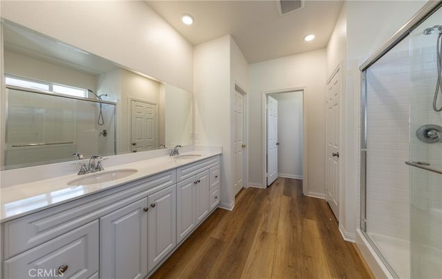 Bathroom, Dual Sink Vanities, Glass Shower, Interior, Recessed Lighting, Wood Texture Flooring