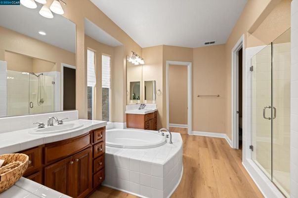 Bathroom, Dual Sink Vanities, Glass Shower, Interior, Recessed Lighting, Tile Countertops, Wood Texture Flooring