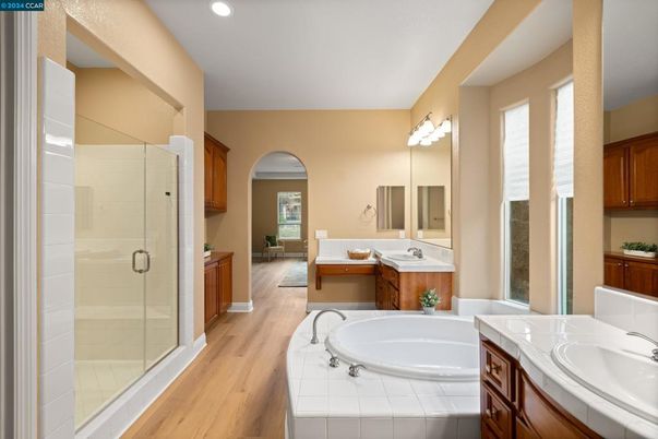Bathroom, Dual Sink Vanities, Glass Shower, Interior, Recessed Lighting, Tile Countertops, Wood Texture Flooring