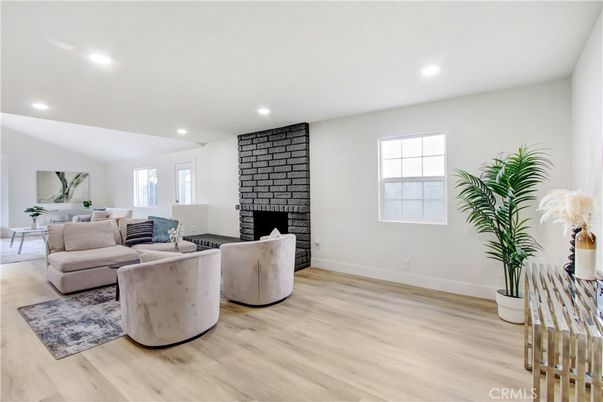 Fireplace, Interior, Living room, Recessed Lighting, Stone Walls, Wood Texture Flooring