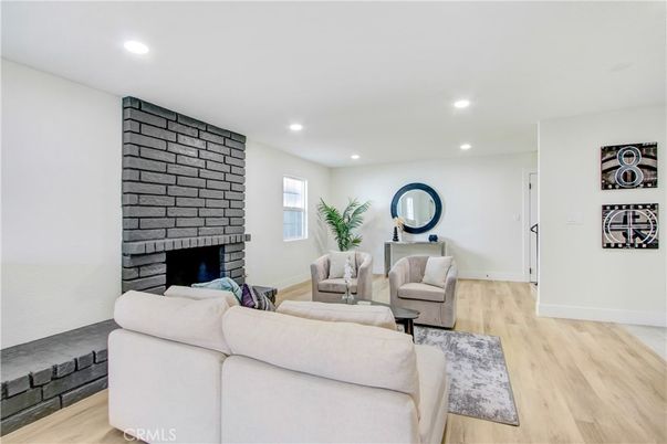 Fireplace, Interior, Living room, Recessed Lighting, Stone Walls, Wood Texture Flooring