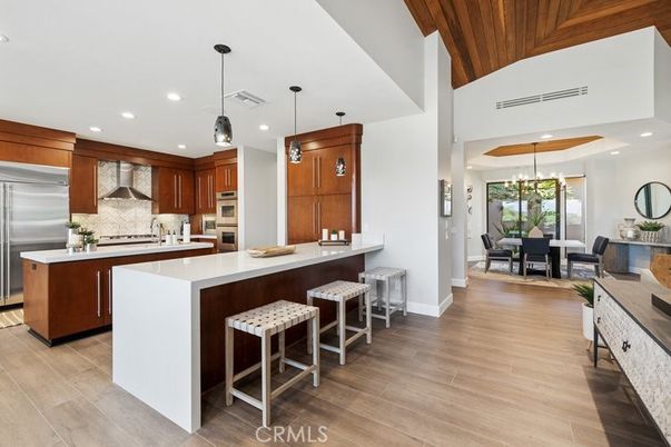 Chandelier, Dining room, Interior, Kitchen, Pendant Lights, Recessed Lighting, Stainless Steel Appliances, Wooden Ceilings, Wood Texture Flooring
