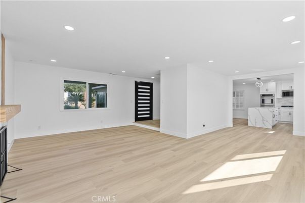 Empty room, Interior, Kitchen, Recessed Lighting, Stainless Steel Appliances, Wood Texture Flooring