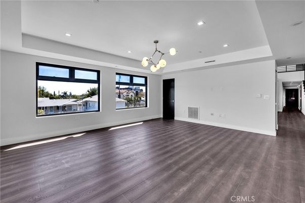 Empty room, Interior, Pendant Lights, Recessed Lighting, Stainless Steel Appliances, Wood Texture Flooring